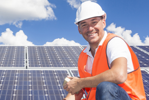 Man smiling while installing solar panels